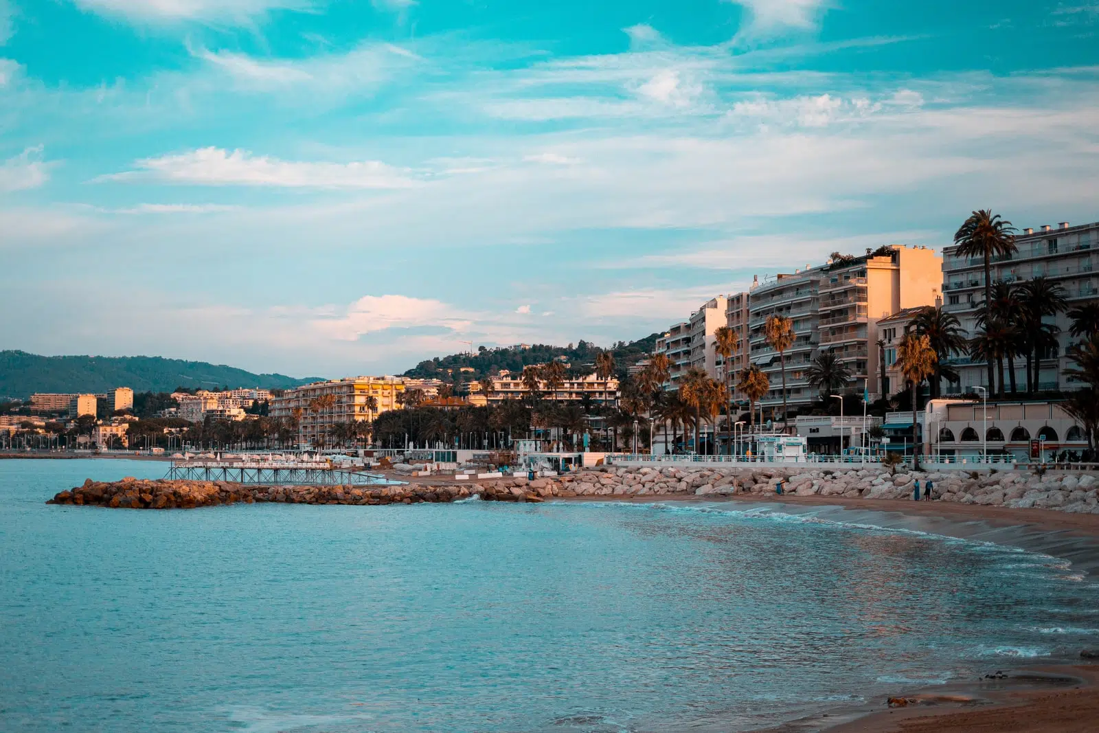 city buildings near body of water under blue sky during daytime